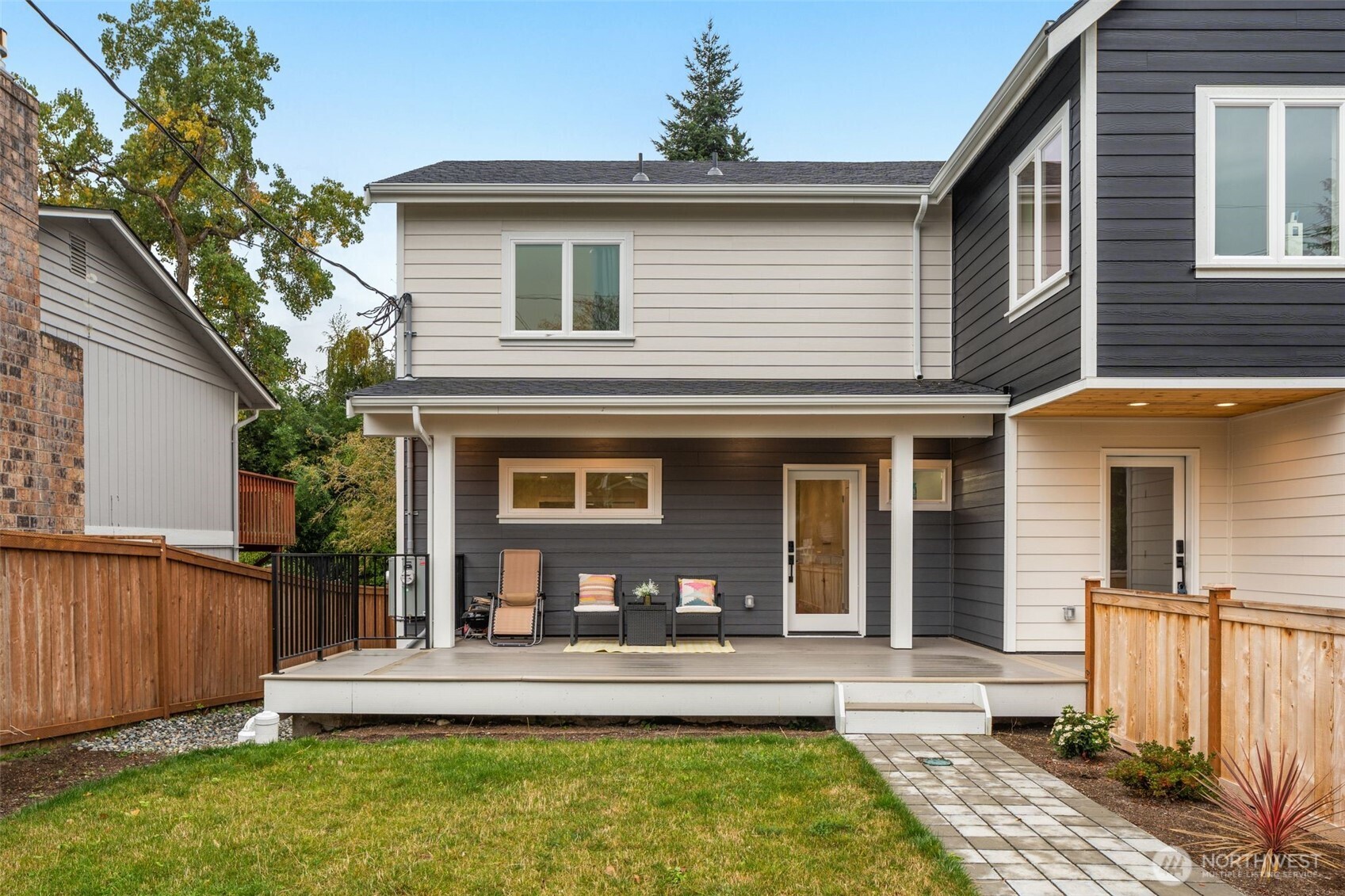 9253 6th Avenue Northwest, Unit B Seattle, WA 98117 - Photo 2 of 24 a front view of a house with a yard table and chairs