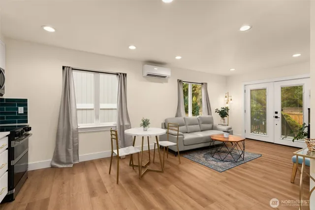a living room with furniture and a wooden floor