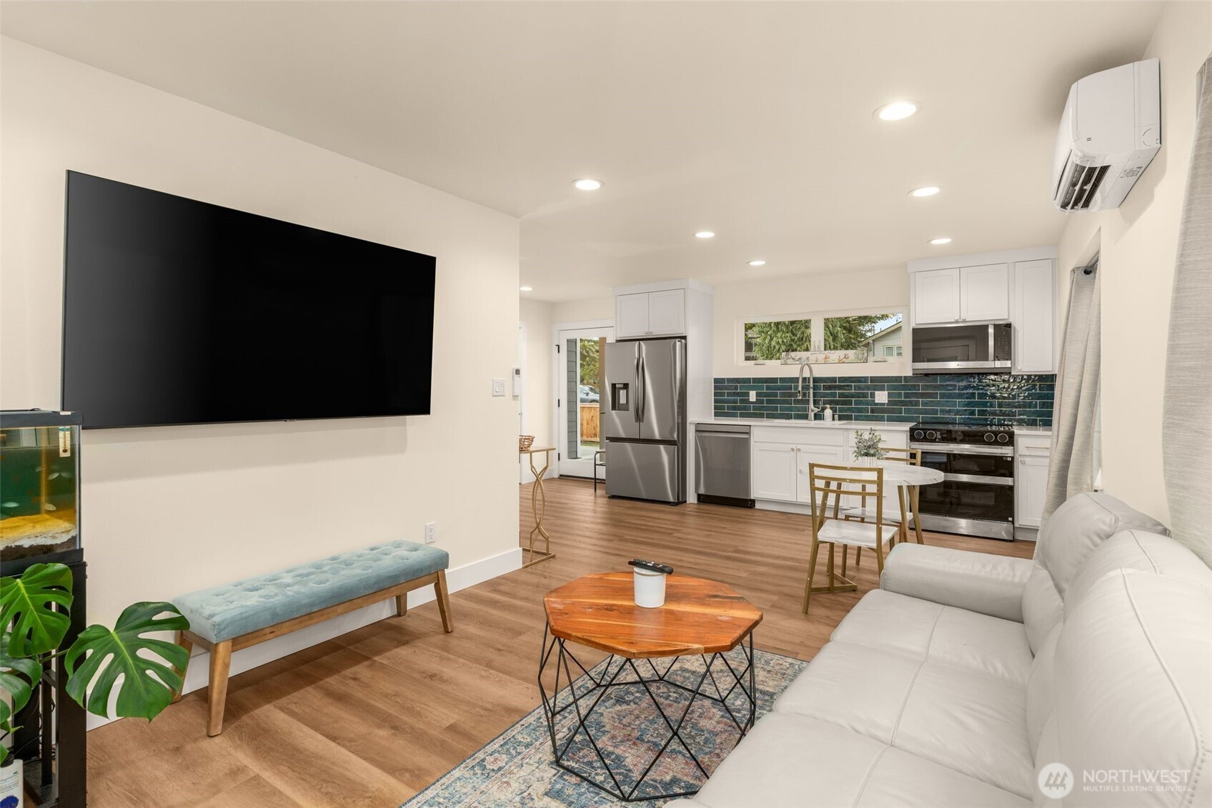 9253 6th Avenue Northwest, Unit B Seattle, WA 98117 - Photo 7 of 24 a living room with furniture and a flat screen tv