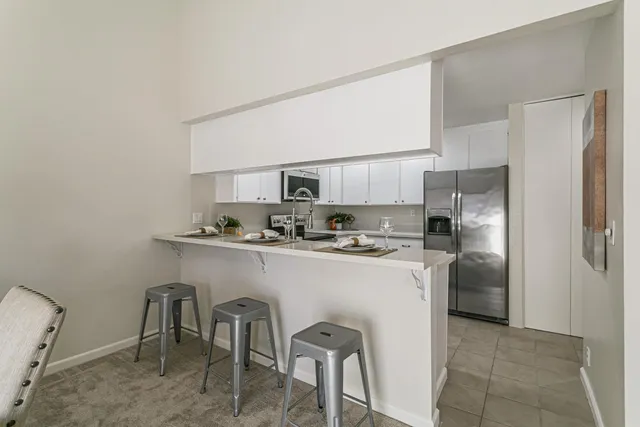 a kitchen with stainless steel appliances a refrigerator and a stove