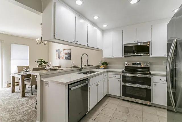 a kitchen with a sink stove and cabinets