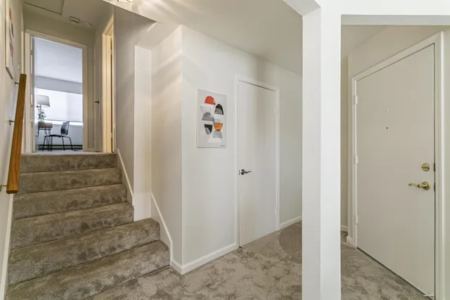 a view of a hallway with wooden floor and entryway