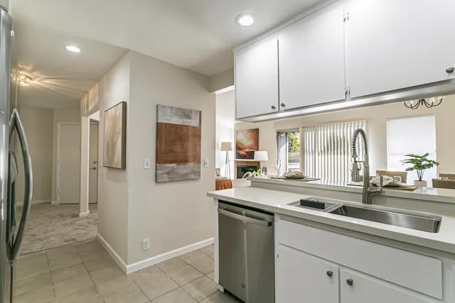 a view of a kitchen with a sink and refrigerator