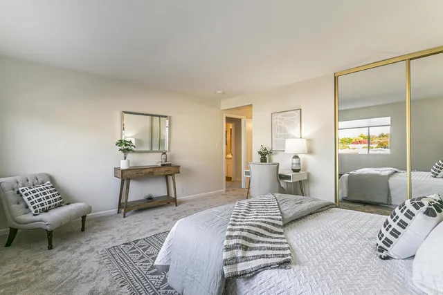 a bedroom with furniture and a wooden floor