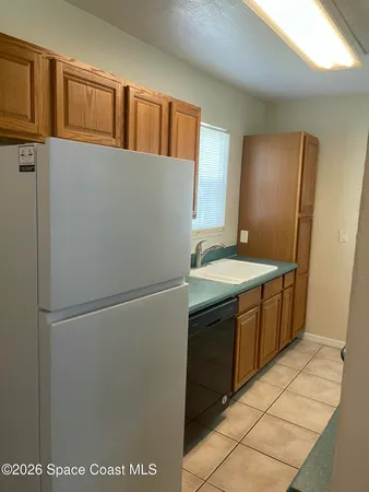 a kitchen with a refrigerator and a sink