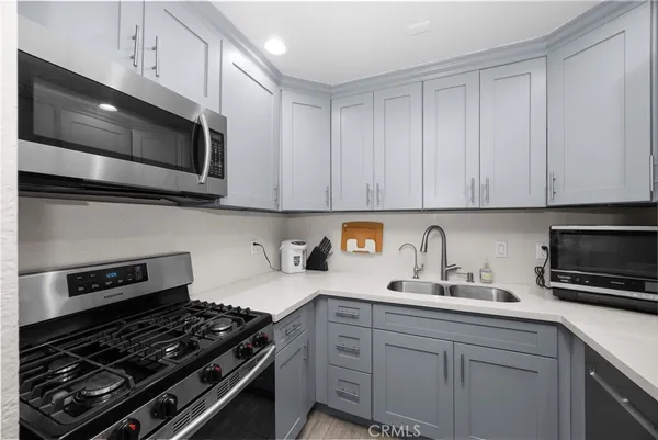 a kitchen with white cabinets and stainless steel appliances