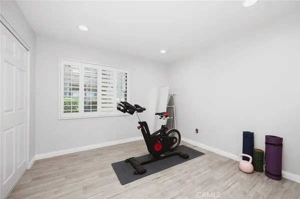a bedroom with a bed a flat screen tv and a couch