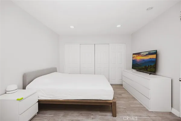 a bedroom with a bed and a flat screen tv