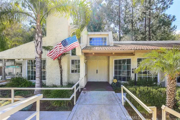 a view of yard and tree in the background