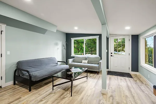 a workspace with wooden floor and a window