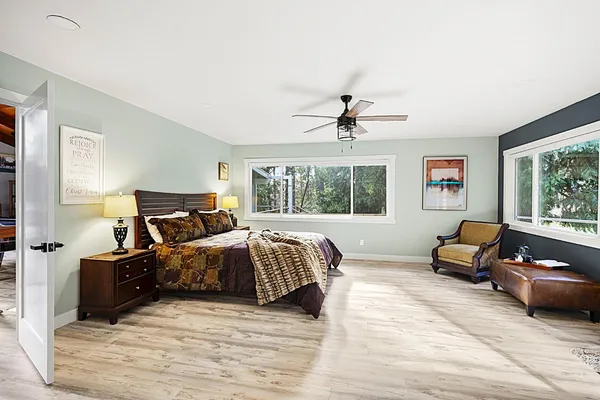 a bedroom with a bed and wooden floor