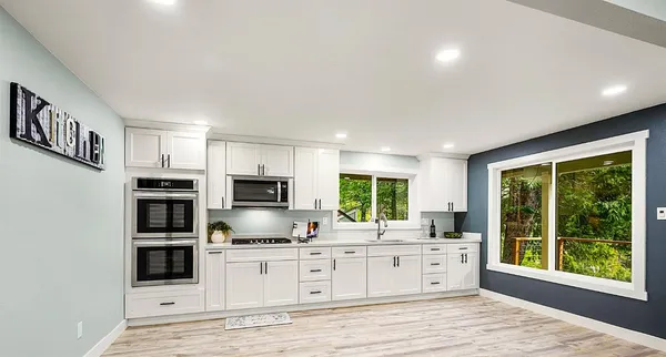 a kitchen with cabinets and steel stainless steel appliances