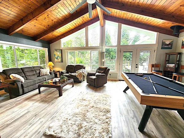 a living room with furniture a large window