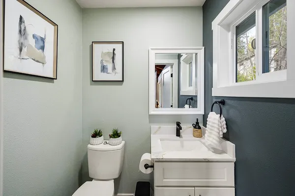 a view of a room with wooden floor and furniture
