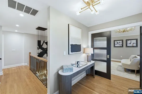 a bedroom with furniture and a wooden floor