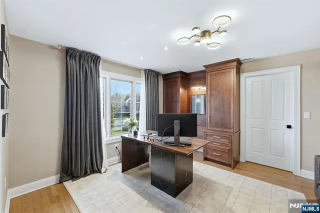 a view of a workspace with furniture and a window