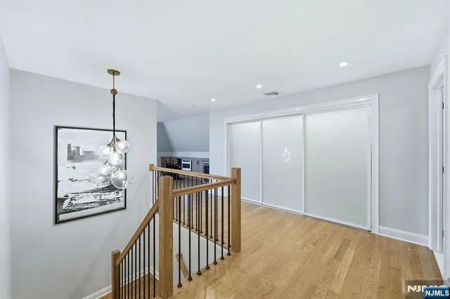 a view of hallway with wooden floor