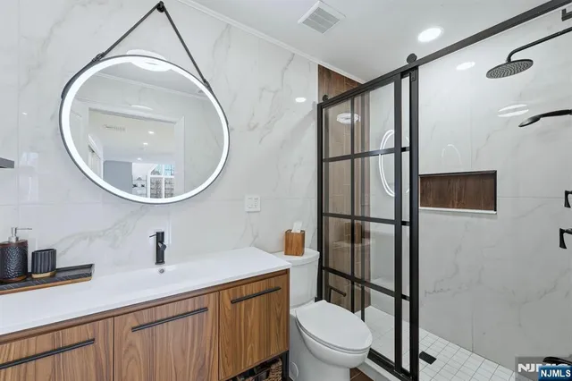 a bathroom with a toilet a sink and a mirror