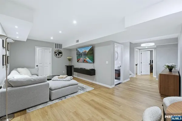 a living room with furniture and a wooden floor