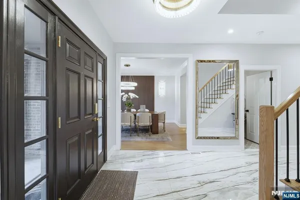 a view of a hallway view with staircase and living room