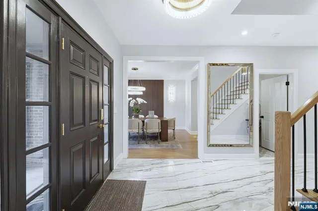 a view of a hallway view with staircase and living room