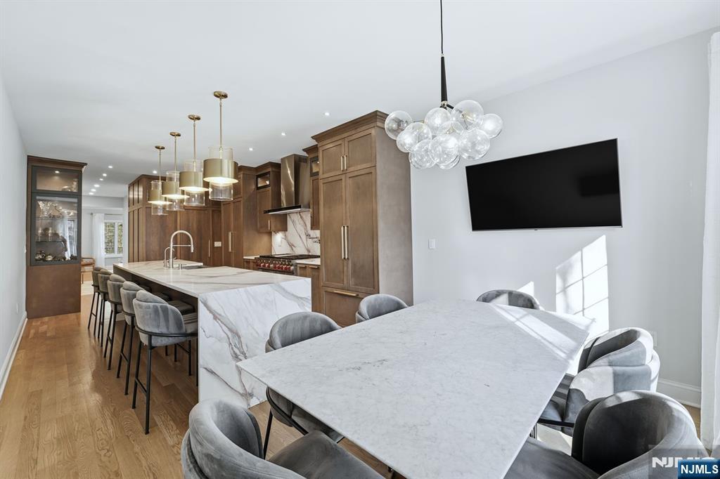 204 Bearwoods Road Park Ridge, NJ 07656 - Photo 8 of 39 a view of a dining room with furniture and a flat screen tv