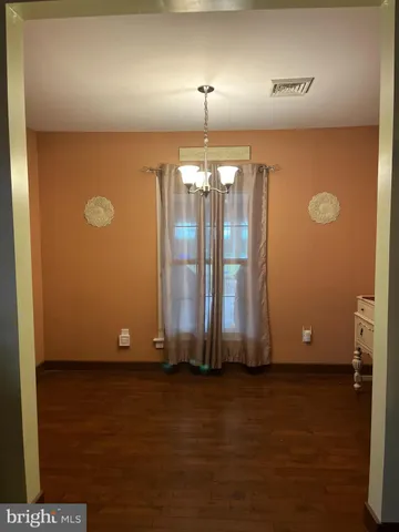 a view of a workspace with furniture and a chandelier