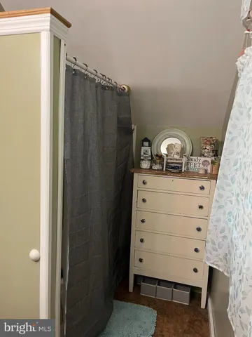 a bed sitting in a bedroom next to a window and furniture