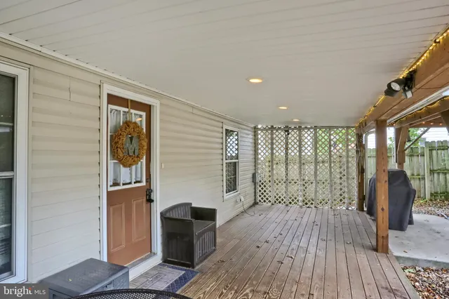 a view of outdoor space with wooden floor and windows