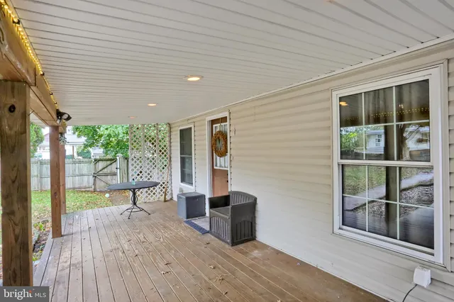 a view of a backyard with wooden fence