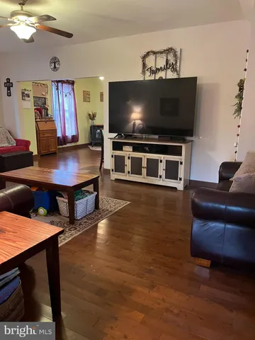 a living room with furniture and a flat screen tv