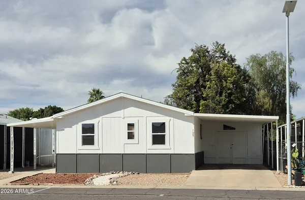 a view of a house with a backyard