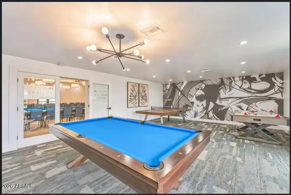 a room with pool table and windows