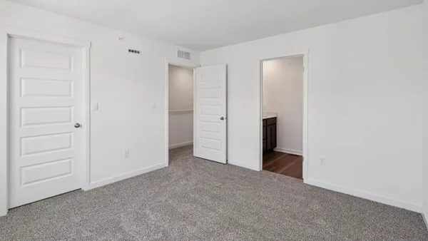 a view of an empty room and closet area
