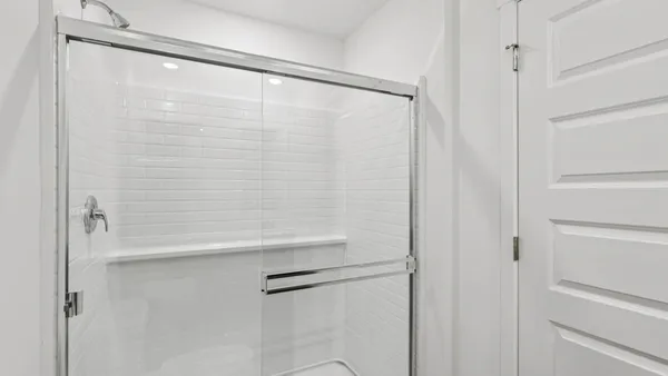 a bathroom with a glass shower door