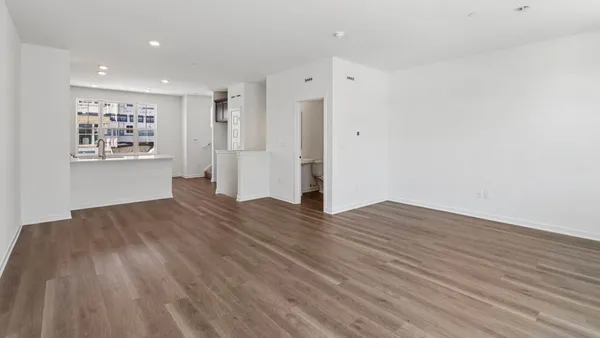 a view of wooden floor and windows in a room