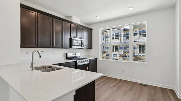 a kitchen with a sink a stove and cabinets