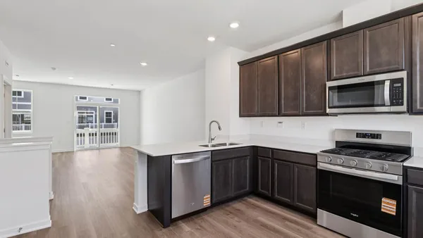a kitchen with stainless steel appliances a stove sink microwave and cabinets