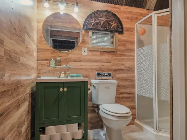 a bathroom with a toilet sink and mirror