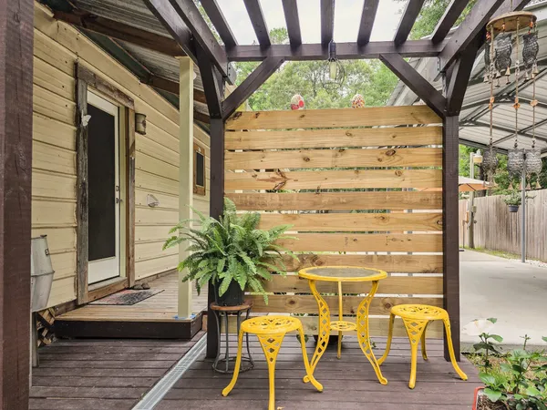 a view of a house with backyard and porch
