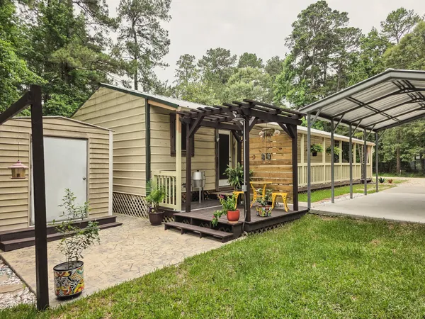 a view of a house with backyard and sitting area