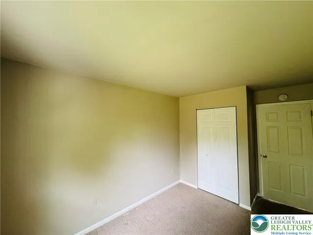 an empty room with a wooden door
