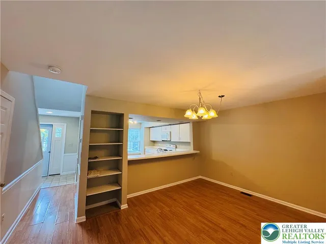 a view of a room with wooden floor and staircase