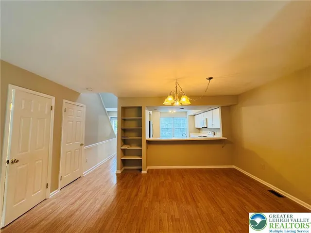 a view of a room with wooden floor