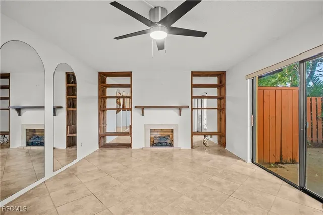 an empty room with windows and entryway