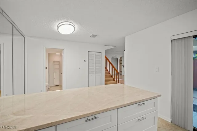 a view of a hallway to rooms