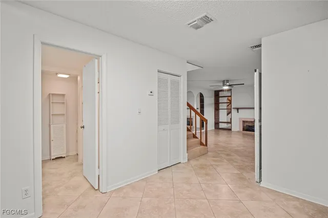 a view of a hallway with wooden shelves