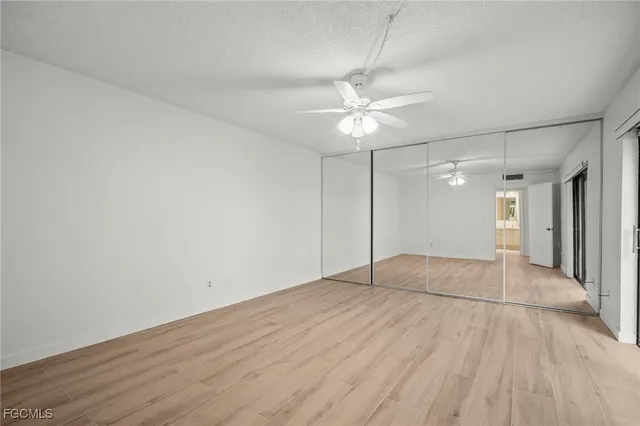 an empty room with fan and entrance