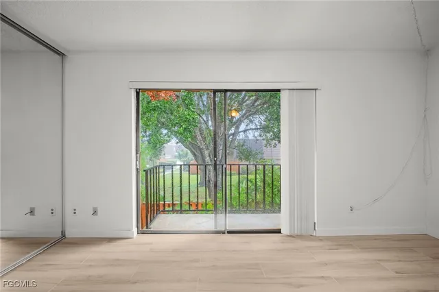 a view of a room with wooden floor and windows