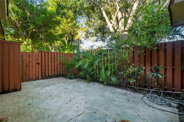 a view of a backyard with wooden fence